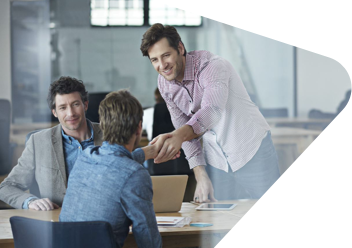 man shaking hands with a colleague in an office