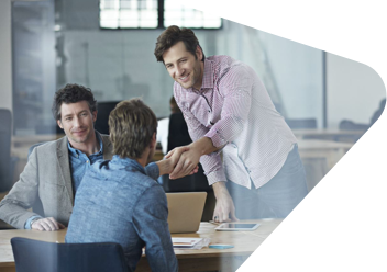 man shaking hands with a colleague in an office