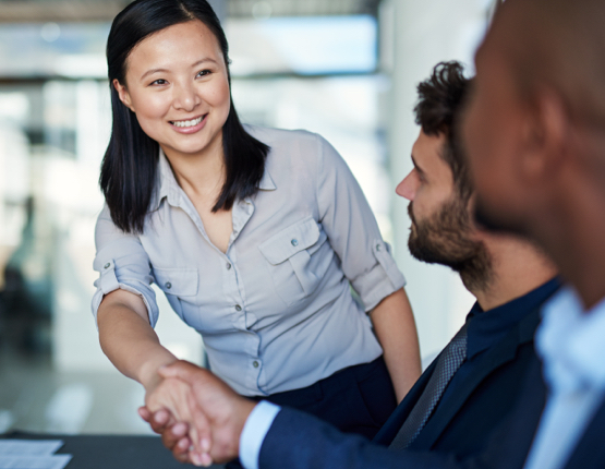 HR representative shaking the hands of potential candidates