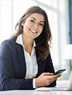 businesswoman smiling with her phone in her hand