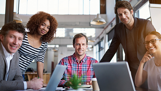 group of people smiling in a meeting