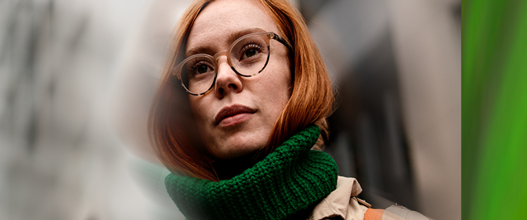 Redheaded woman wtih glasses wearing a green scarf