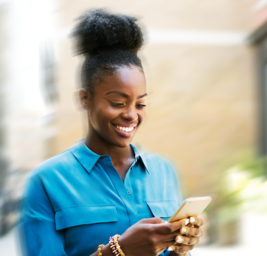 Woman consulting her cell phone while smiling