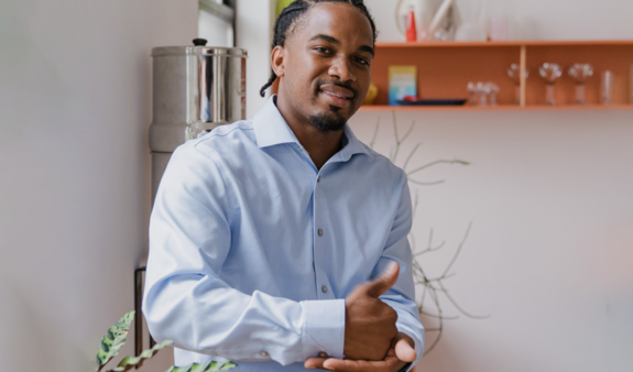 Man in his office using sign language to say he will help you