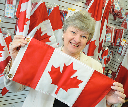 CEO and president Cecilia Burke, with various canadian flags