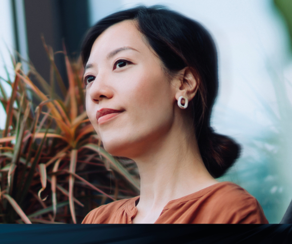 Woman deep in thought in front of plants