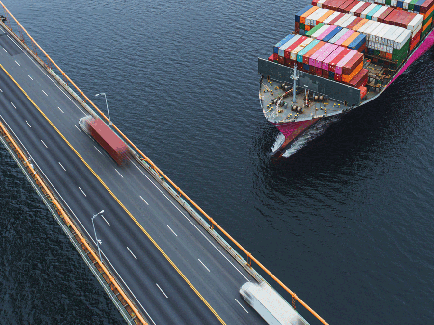 cargo ship navigating near a bridge
