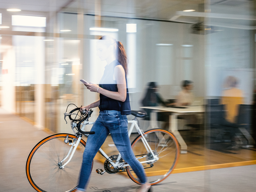 businesswoman taking her bike to her workplace
