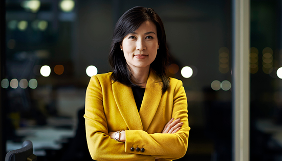 woman entrepreneur in a yellow blazer confidently looking straight ahead