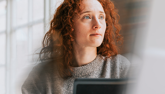 redhead woman sitting at desk with computer