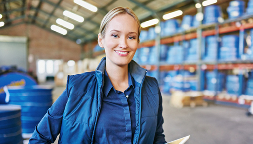 woman standing in a warehouse holding a tablet