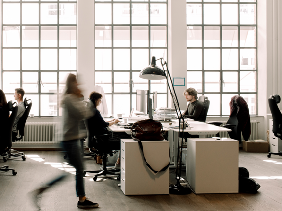  blur motion of a woman walking in an office