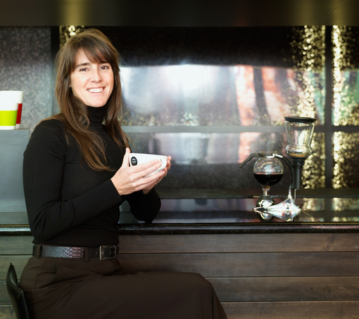 elana rosenfeld drinking coffee, sitting at a counter
