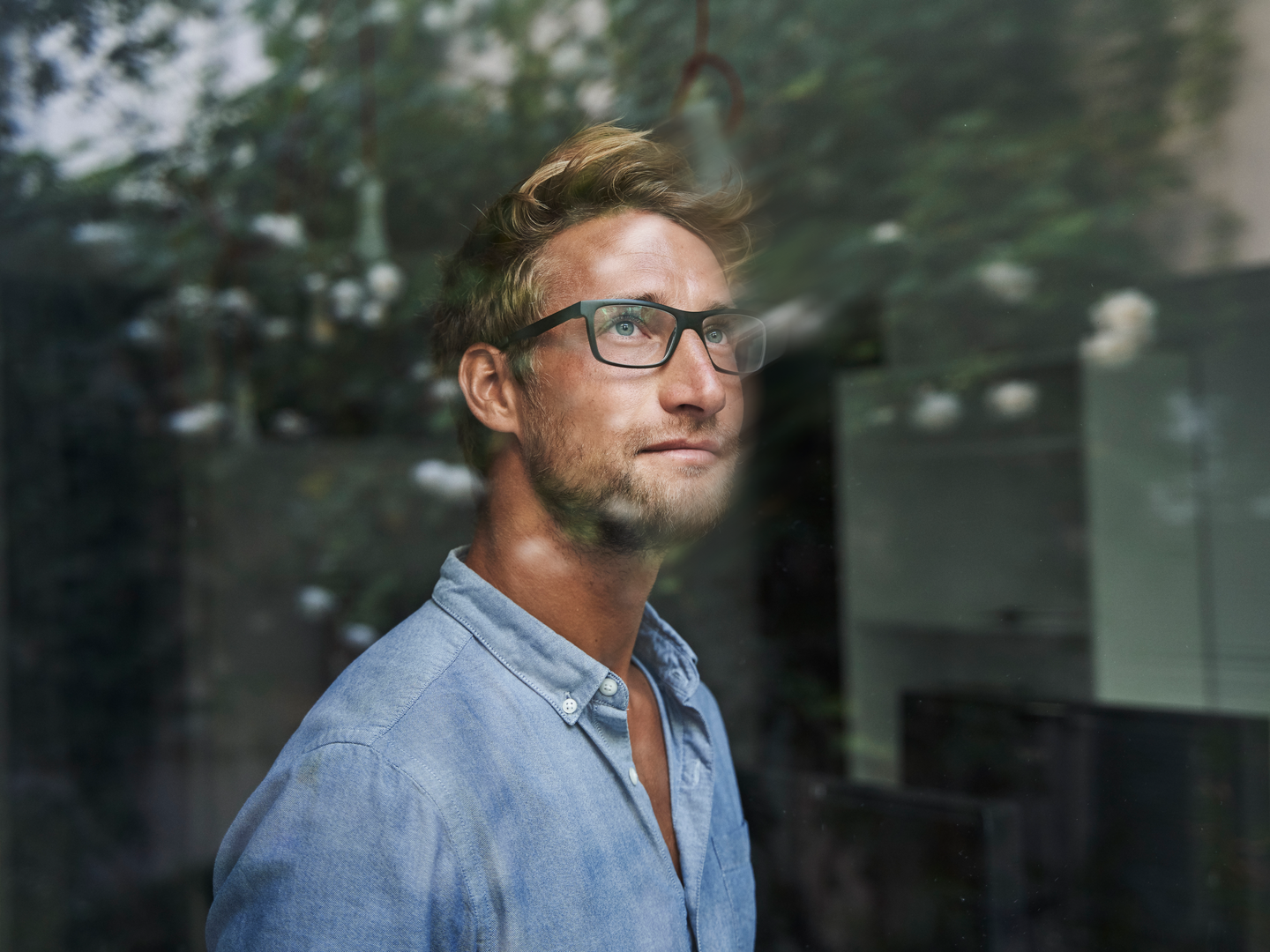 A businessman behind windowpane in office