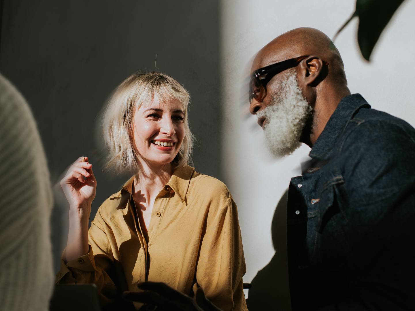 A man and a woman sitting side-by-side in a modern environment