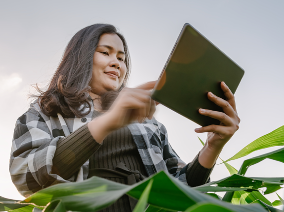 woman in a field with an ipad