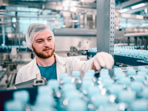 hairnet wairing man in bottling plant