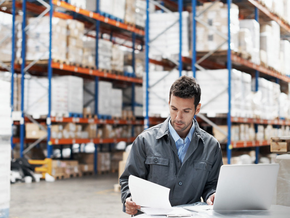 man working in a factory, looking to finance his exports