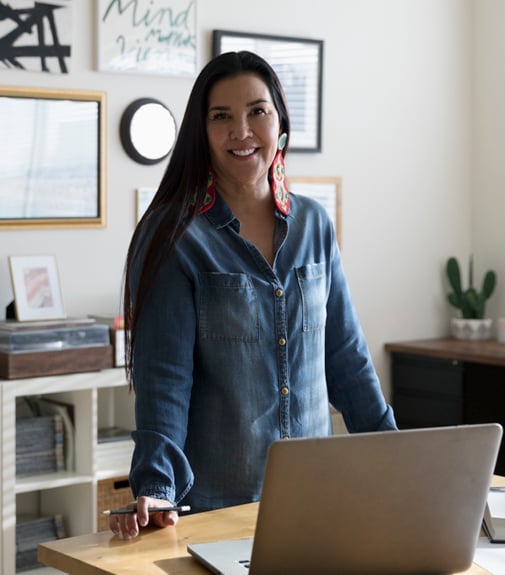 woman standing in her office with a pencil in her hand