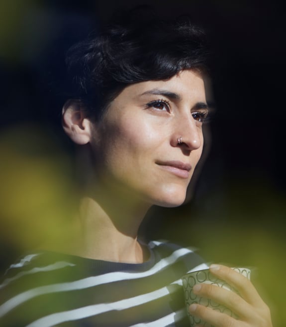 a dreamy woman looking through a window